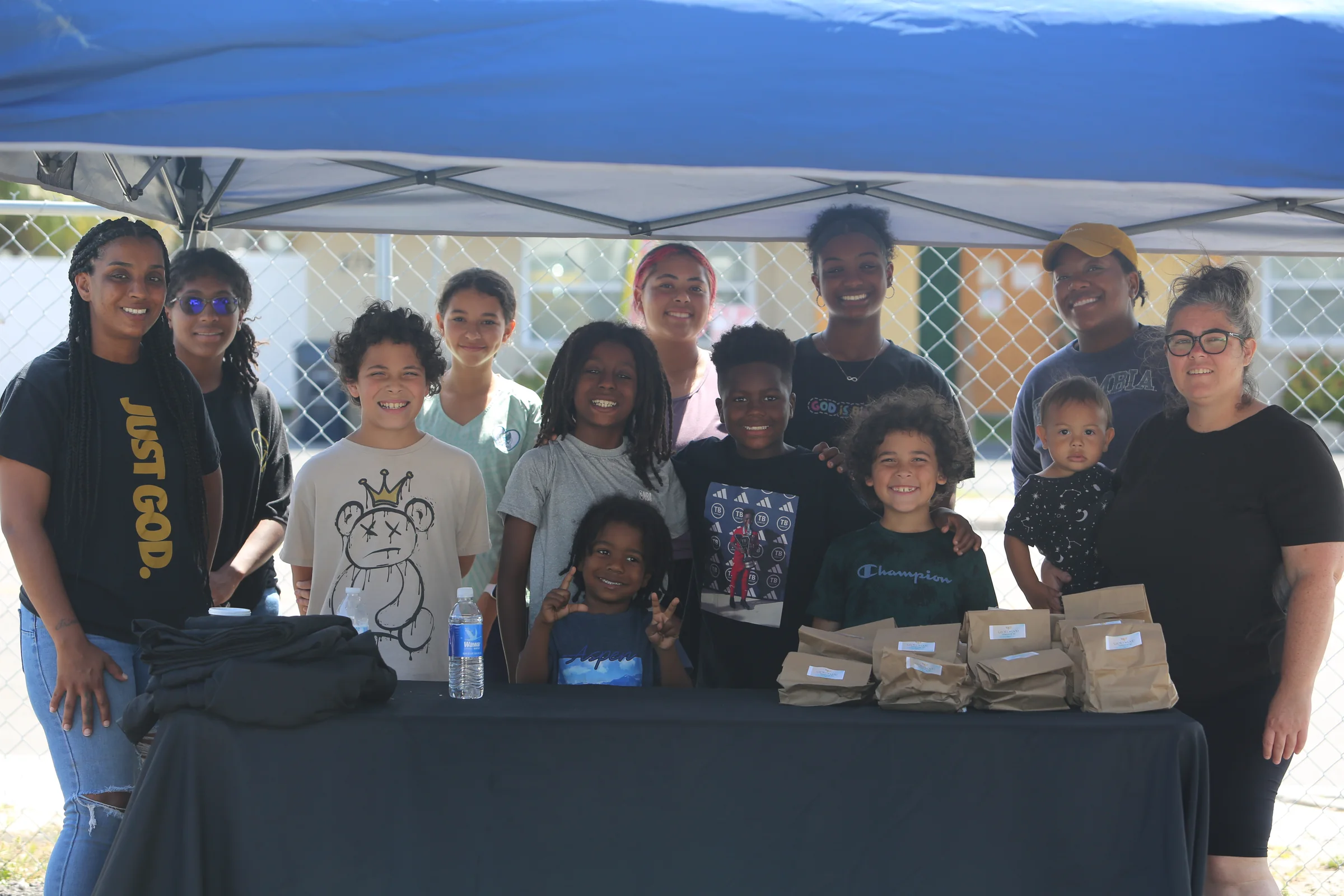 Glory to God Foundation volunteers gathered behind an outreach table